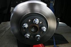 DIY - Disk Brake Removal and Sanding with Garnet Paper to resolve Brake Problem.-image-11-brake-rotor-being-held-on-with-lug-nuts..jpg